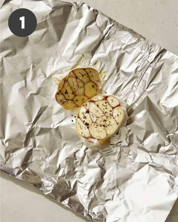 Roasted garlic on foil with olive oil and salt and pepper.