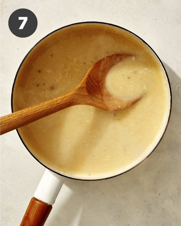 Roasted garlic gravy in a pot simmering.