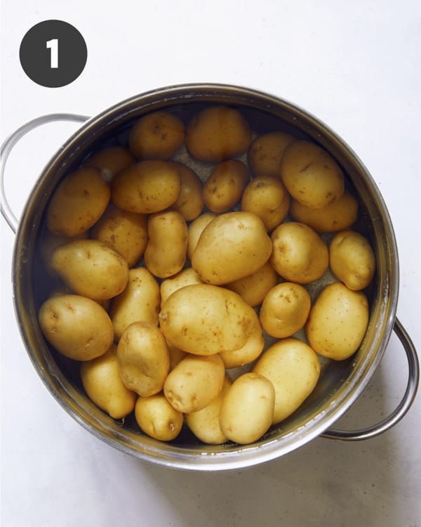 Potatoes in a pot of water to be boiled.