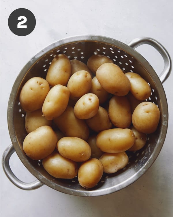 Cooked potatoes in a colander.