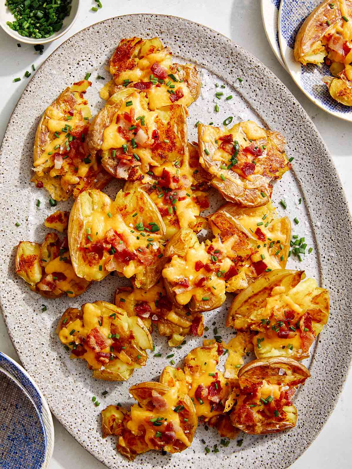 Smashed potatoes on a plate.