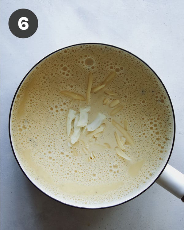 Melting cheese in a sauce for stovetop mac and cheese.