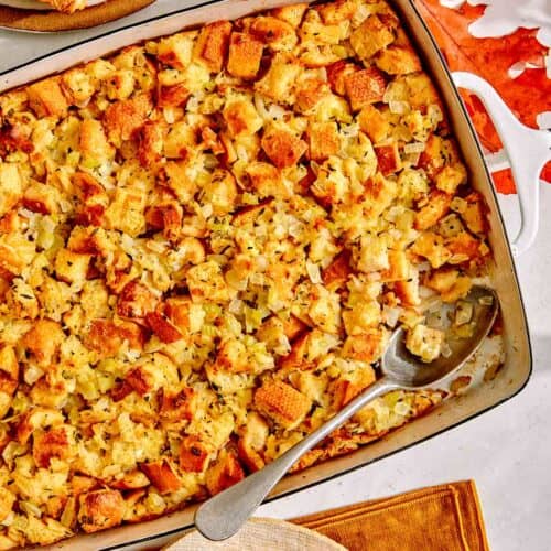 Stuffing in a baking dish with a scoop taken out.