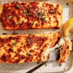 Air fryer salmon with lemon on the side.