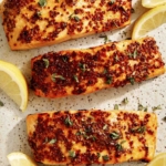 Air fryer salmon with lemon on the side.