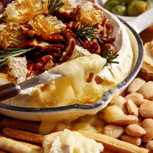 Baked brie on a platter with crackers.