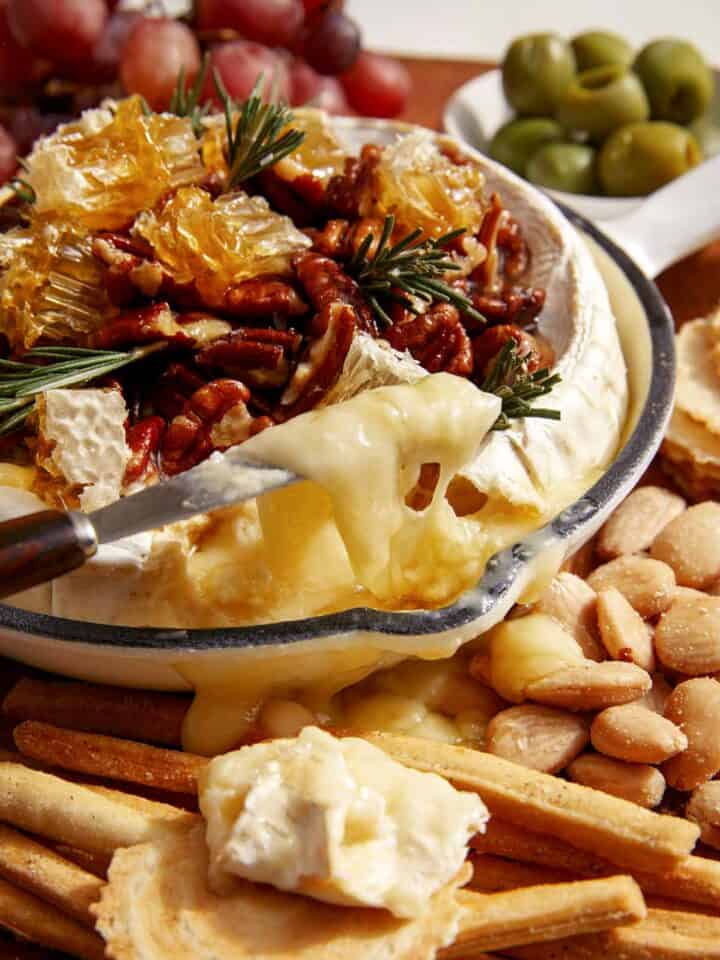 Baked brie on a platter with crackers.