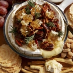 Baked brie on a platter with crackers.