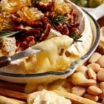 Baked brie on a platter with crackers.