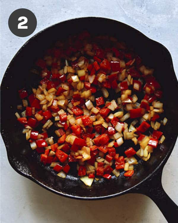 Vegetables sautéd in a cast iron skillet.