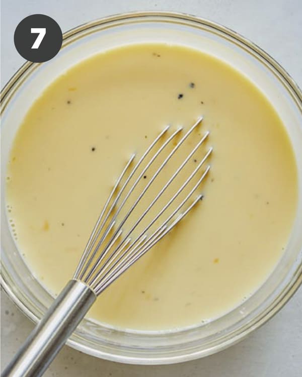 Egg mixture in a glass bowl for breakfast casserole.