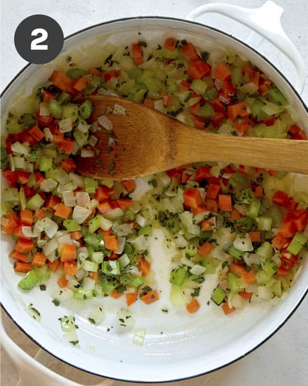 Vegetables in a pot with thyme and sage.