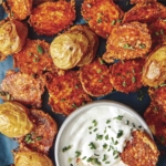 Crispy parmesan potatoes served on a platter.