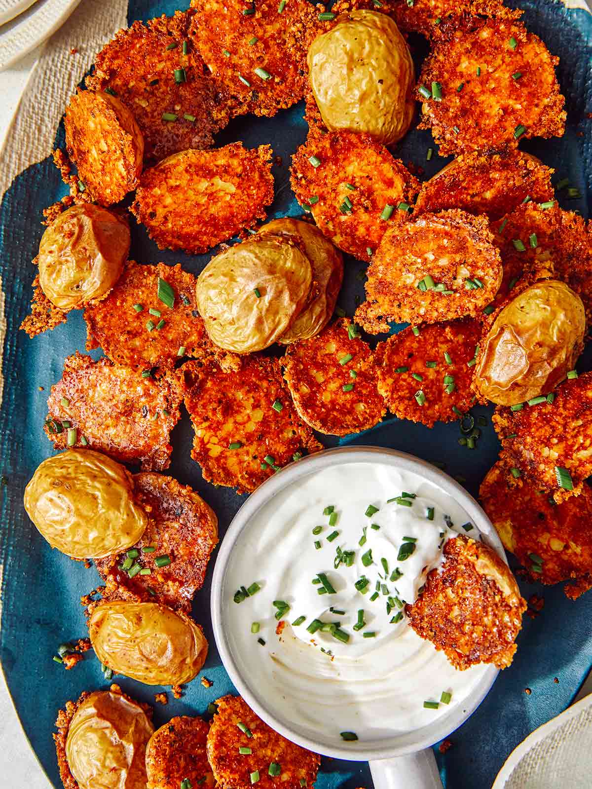 Crispy parmesan potatoes served on a platter.
