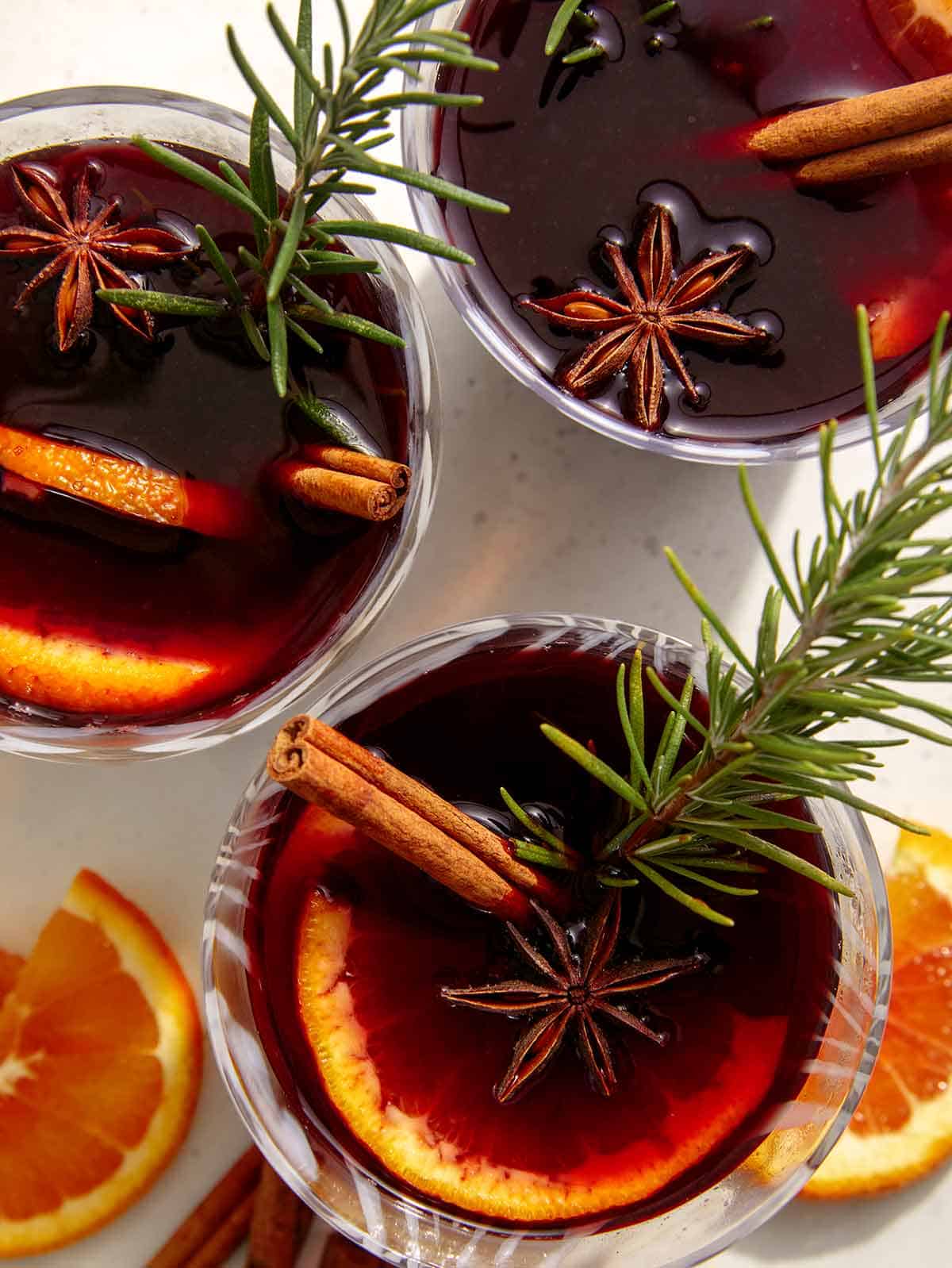 Mulled wine in three glasses with garnish. 