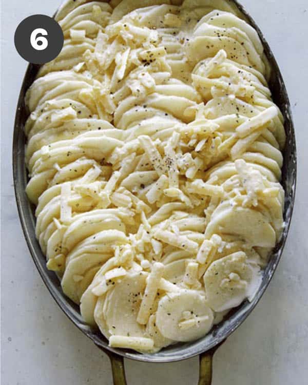 Potatoes gratin in a casserole dish before its baked.