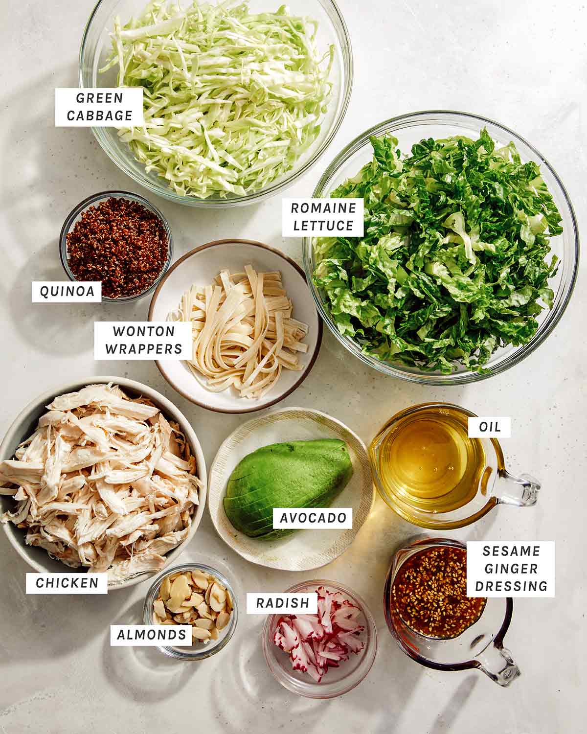 Sesame ginger chicken salad ingredients on a kitchen table.