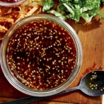 Sesame ginger salad dressing with salad ingredients on the side.