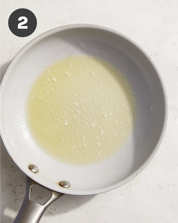 Melted butter in a skillet to make the topped for baked brie.