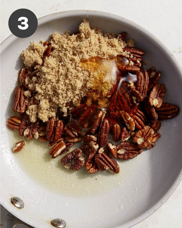 Pecans being cooked in a skillet. 