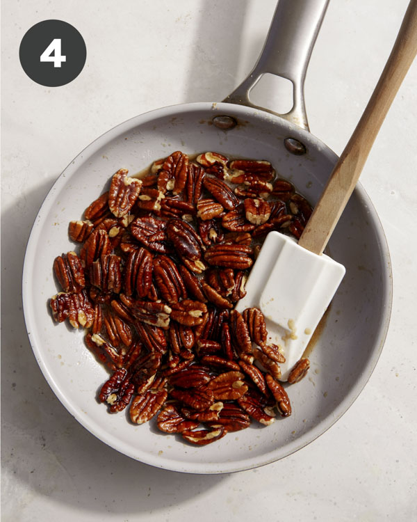 Pecans being candied in a skillet. 