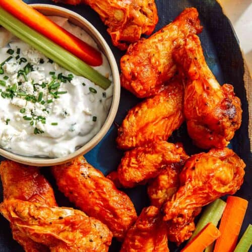 Air fryer buffalo wings on a platter being served.