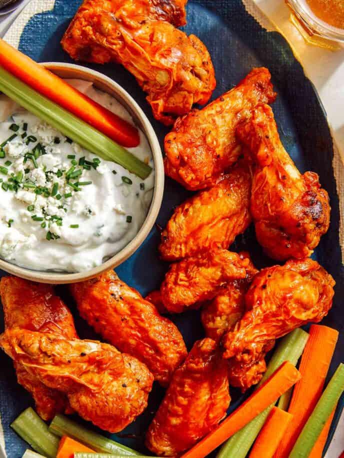 Air fryer buffalo wings on a platter being served.