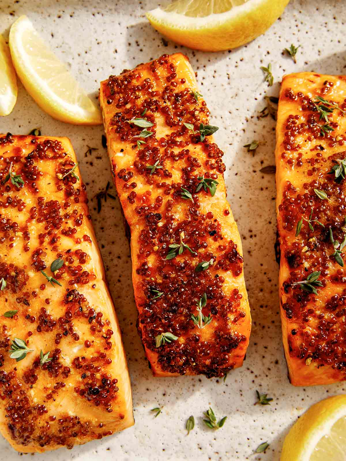 Air fryer salmon on a platter with lemon. 