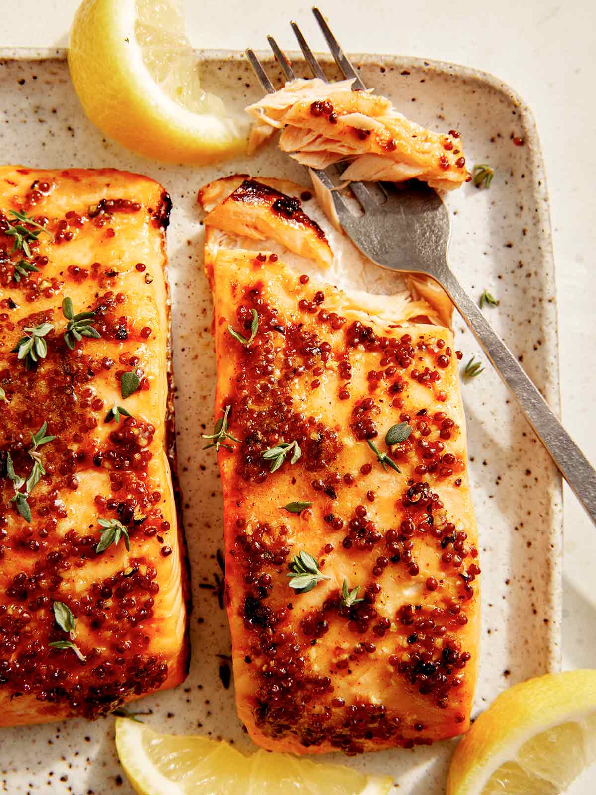 Air fryer salmon on a platter with lemon. 