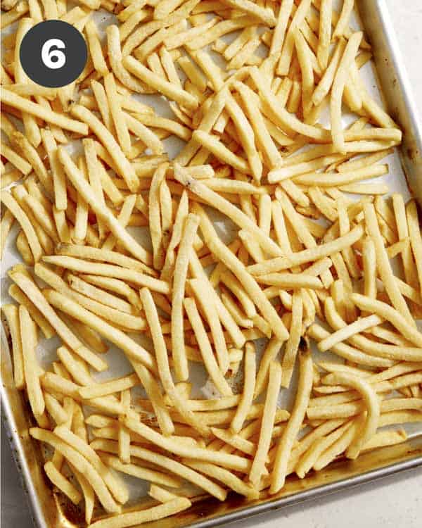Fries on a baking sheet after they have been cooked. 