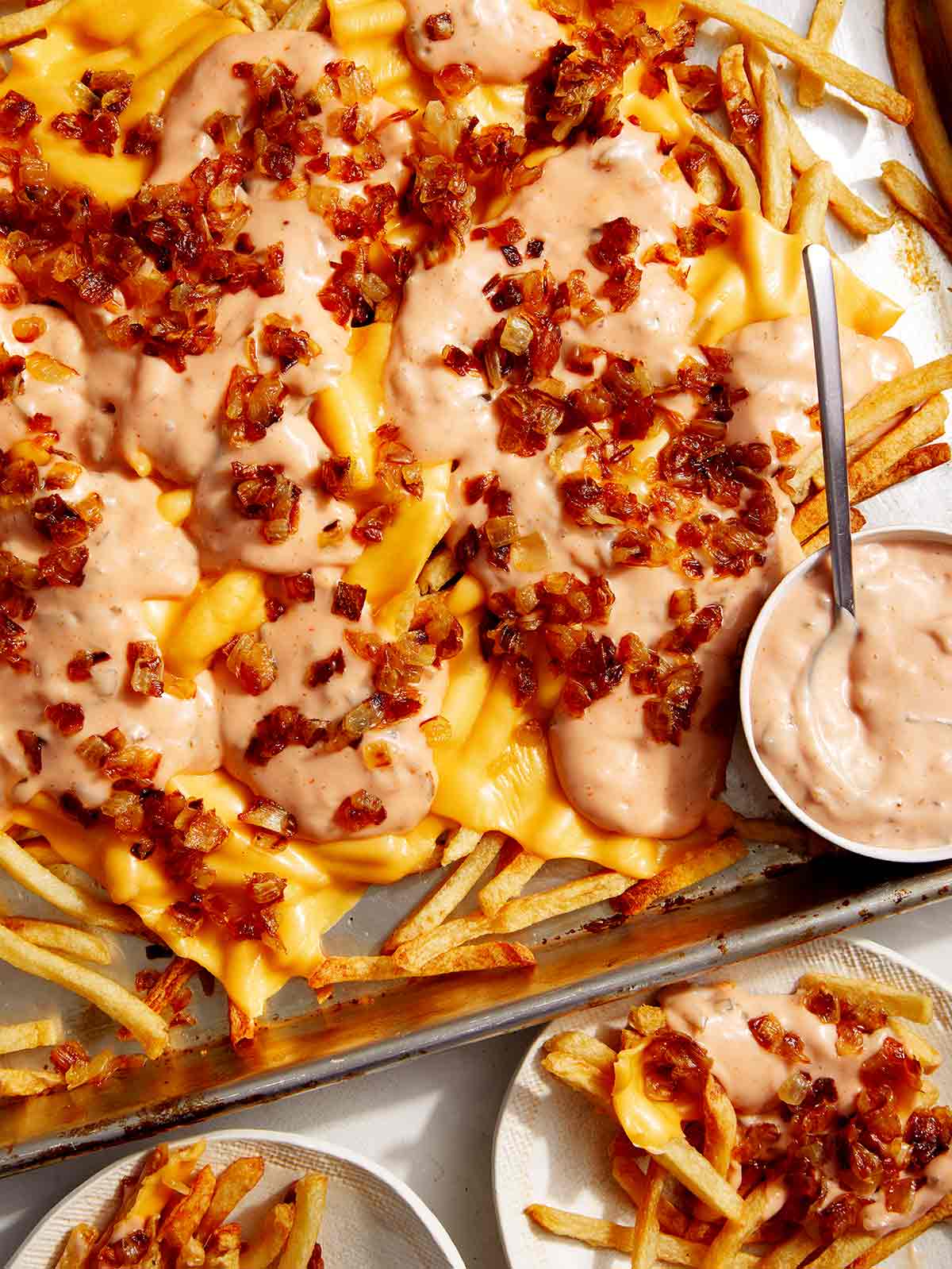 Animal style fries on a baking sheet. 