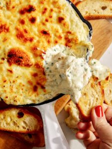 Baked garlic bread dip in a skillet.