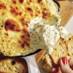 Baked garlic bread dip in a skillet.