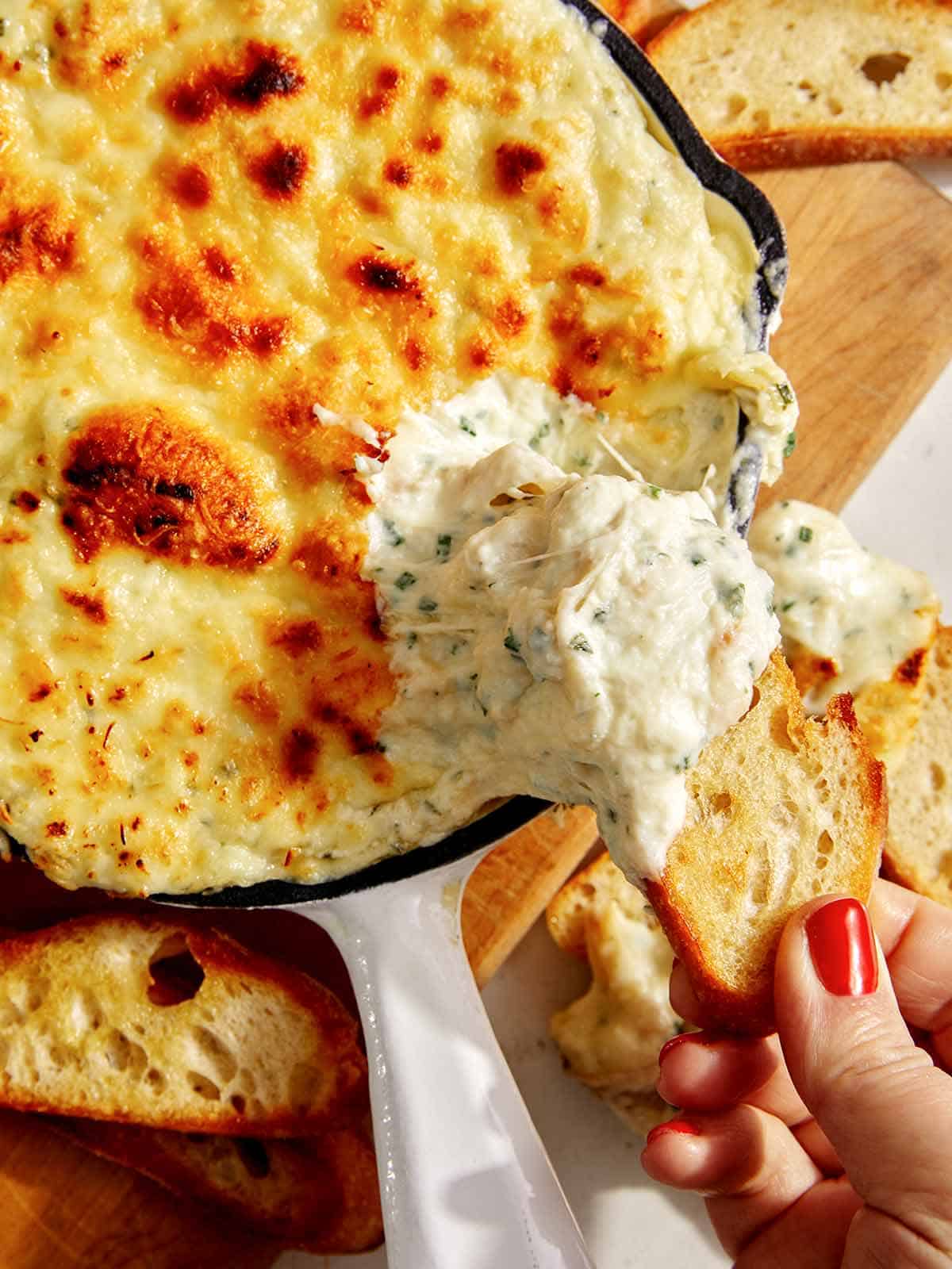 Baked garlic bread dip in a skillet. 