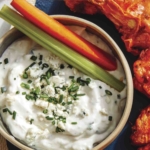 Homemade blue cheese dressing recipe in a bowl on a platter.