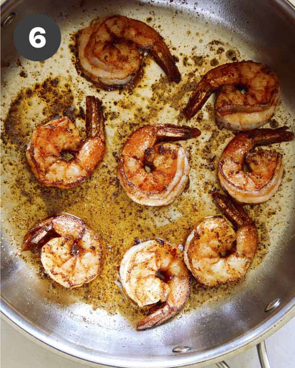 Cajun shrimp cooking in a skillet.