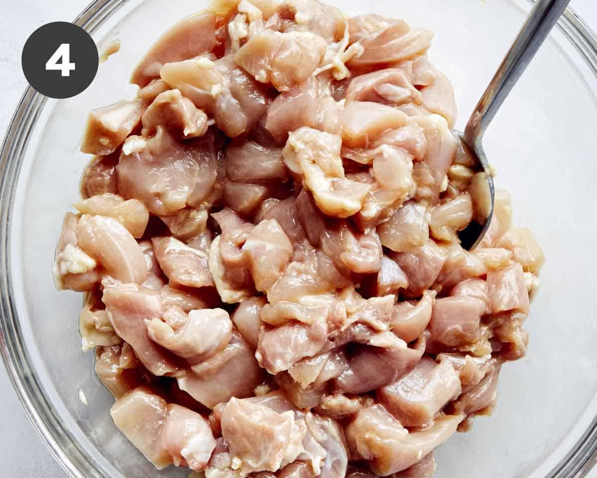 Cashew chicken marinated in a bowl.