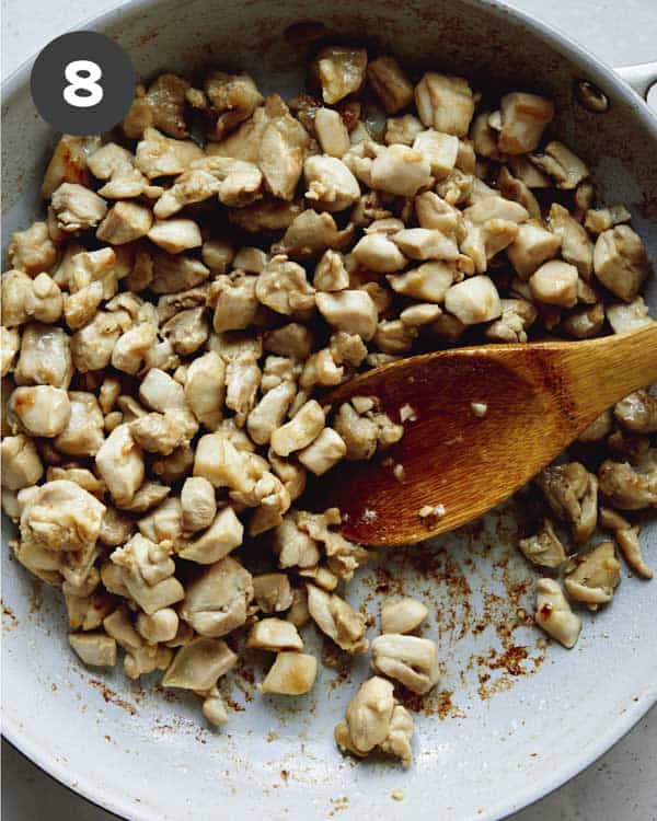 Chicken in a skillet to make a cashew chicken recipe.