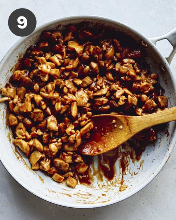 Cashew chicken in a skillet with sauce.