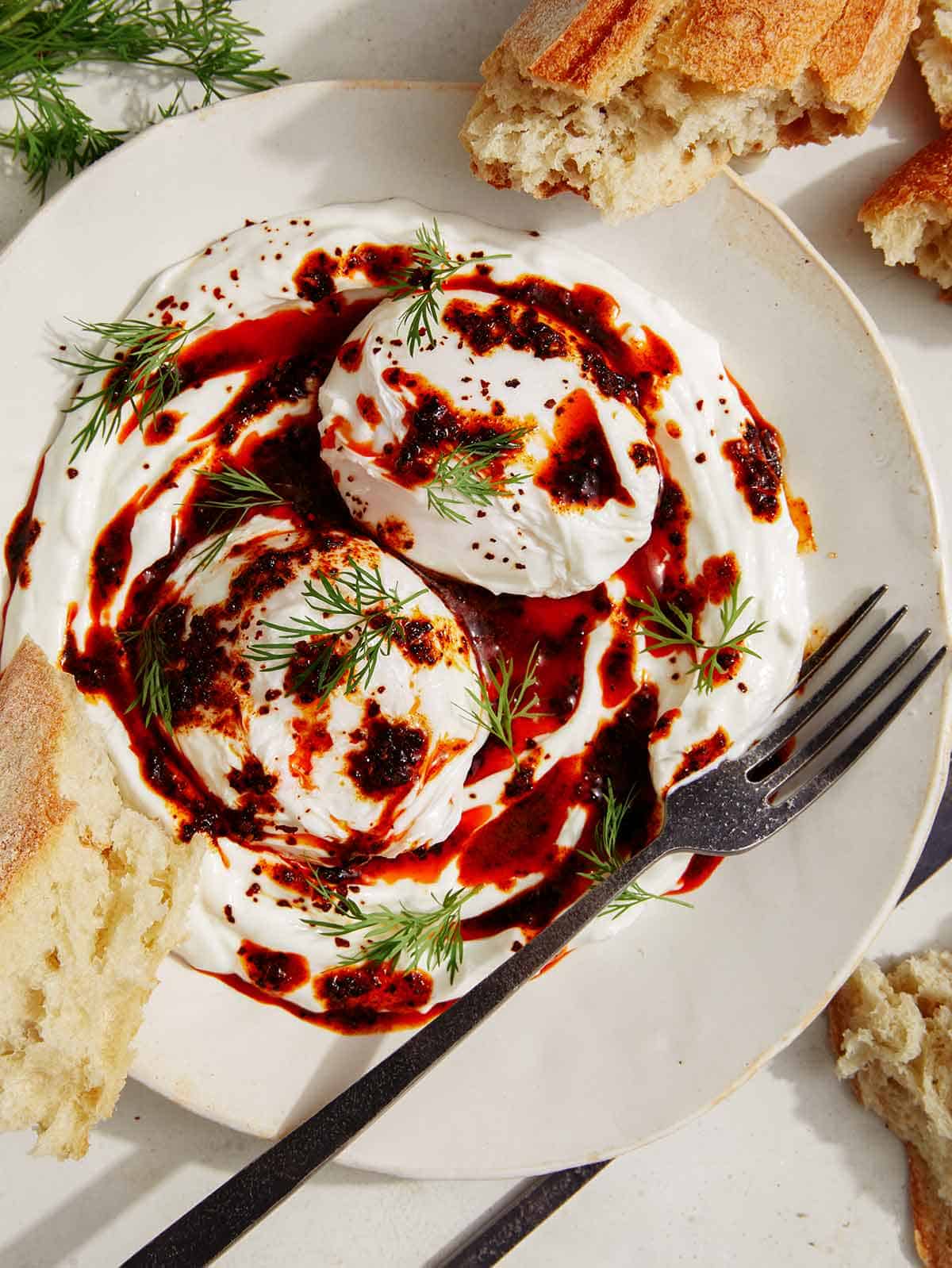 Turkish eggs (cilbir) on a platter ready to be eaten. 