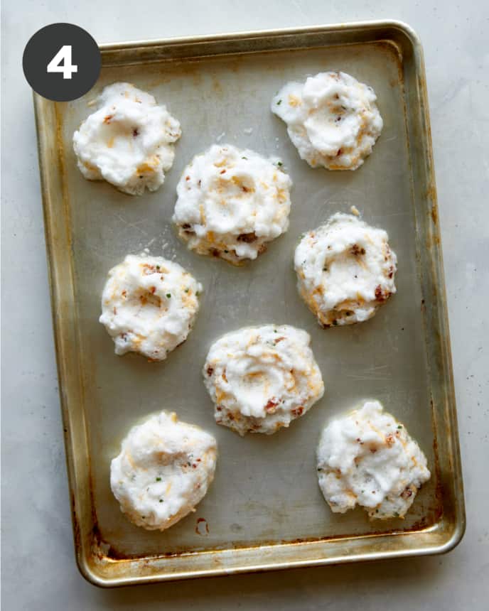 Egg clouds on a baking sheet ready to be baked. 