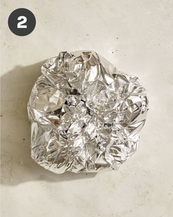 Garlic and shallots wrapped in foil.