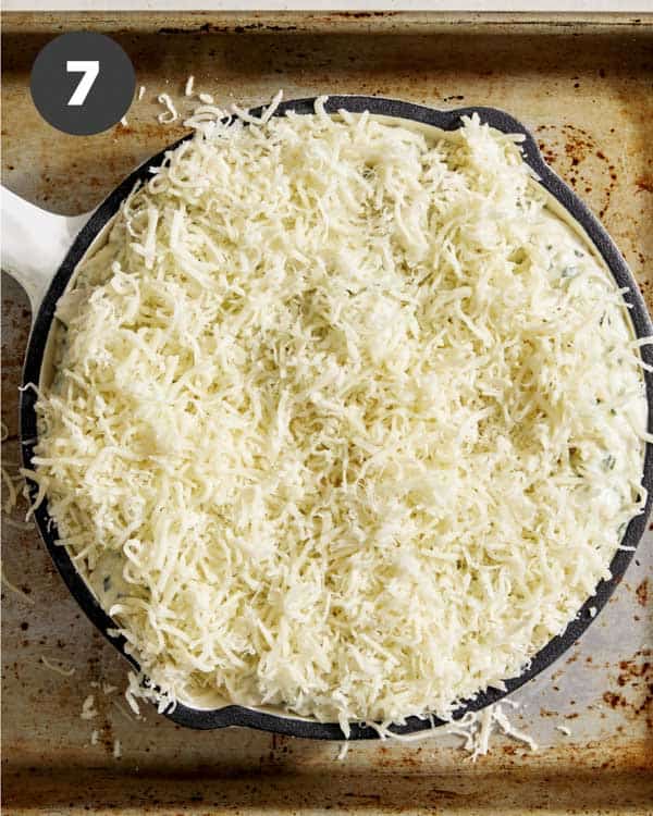 Garlic bread dip with cheese sprinkled on top.
