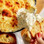 Baked garlic bread dip in a skillet.