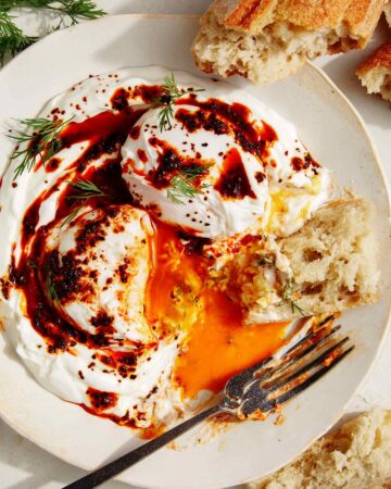 Turkish eggs or cilibir eggs recipe with a piece of bread in it.
