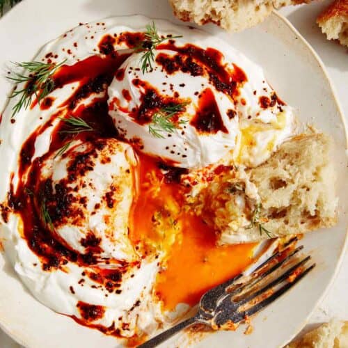 Turkish eggs or cilibir eggs recipe with a piece of bread in it.