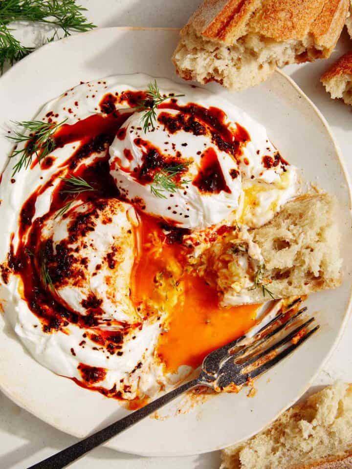 Turkish eggs or cilibir eggs recipe with a piece of bread in it.