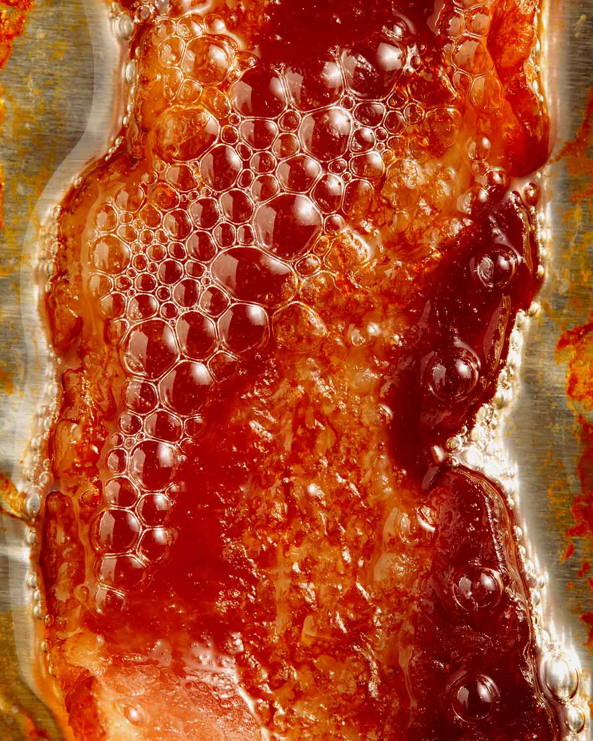 Bacon freshly cooked with bacon grease.