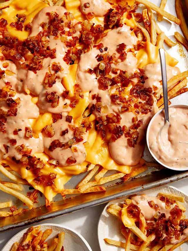 french fries topped with creamy sauce and grilled onions