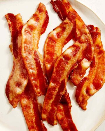 Cooked bacon on a platter ready to be served.